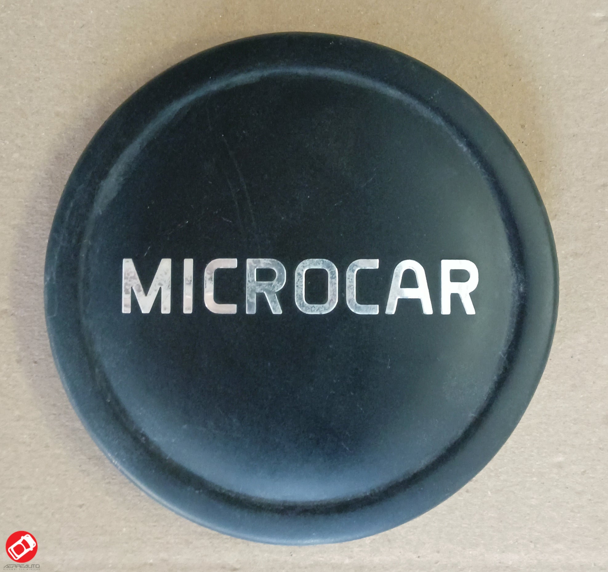 1408352 LOGO COPRICERCHIO NERO MICROCAR M.CROSS DUE M.GO 3 4 5